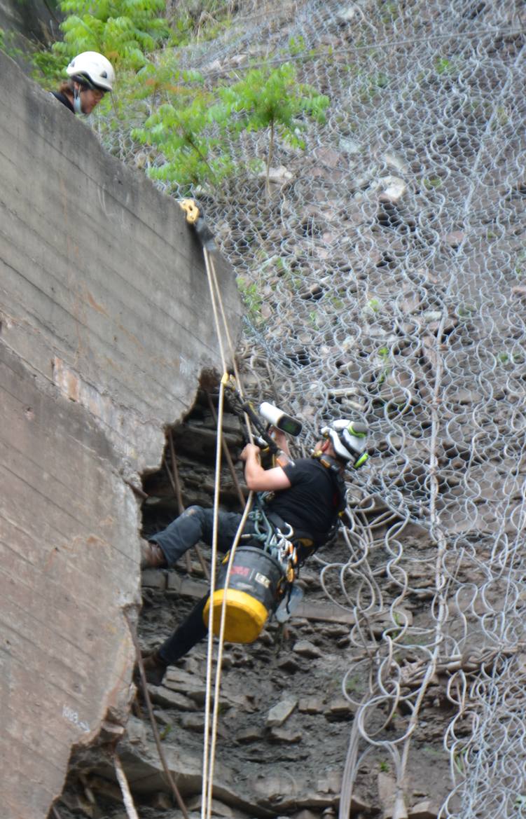 Rope access scanning on a netted rock face
